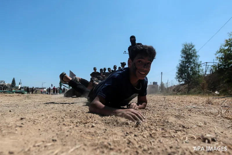 Young Palestinians attend a military summer camp organised by the Islamic Jihad Movement, in Gaza City, June 29, 2021. Photo by Mohammed Dahman Young Palestinians attend a military summer camp organised by the Islamic Ji...