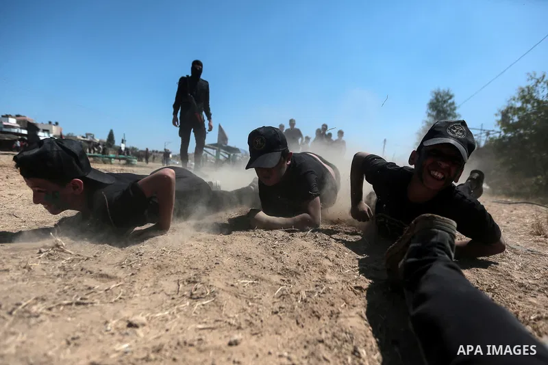 Young Palestinians attend a military summer camp organised by the Islamic Jihad Movement, in Gaza City, June 29, 2021. Photo by Mohammed Dahman Young Palestinians attend a military summer camp organised by the Islamic Ji...