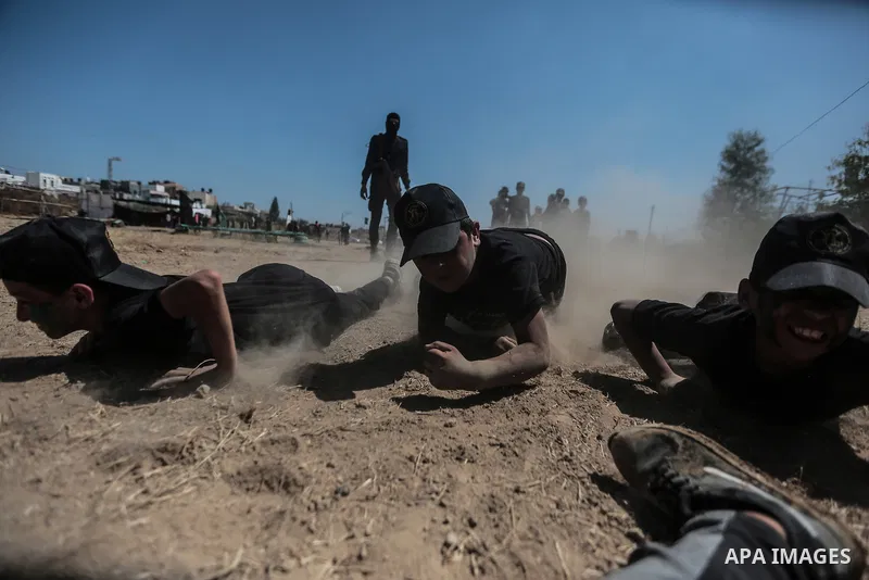 Young Palestinians attend a military summer camp organised by the Islamic Jihad Movement, in Gaza City, June 29, 2021. Photo by Mohammed Dahman Young Palestinians attend a military summer camp organised by the Islamic Ji...