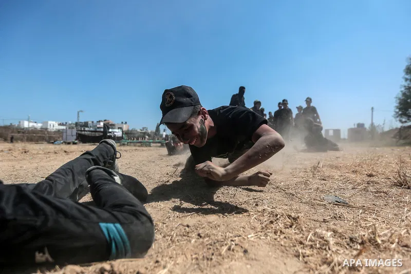 Young Palestinians attend a military summer camp organised by the Islamic Jihad Movement, in Gaza City, June 29, 2021. Photo by Mohammed Dahman Young Palestinians attend a military summer camp organised by the Islamic Ji...