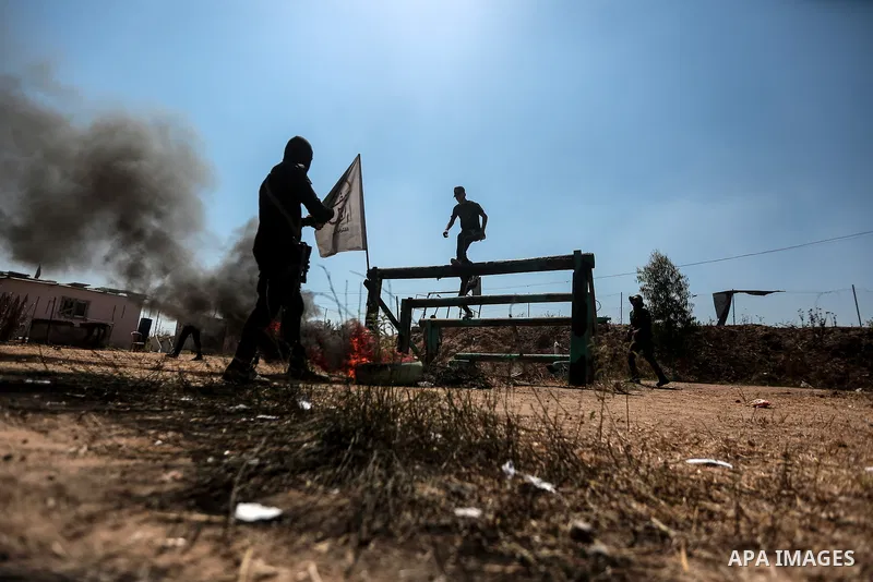 Young Palestinians attend a military summer camp organised by the Islamic Jihad Movement, in Gaza City, June 29, 2021. Photo by Mohammed Dahman Young Palestinians attend a military summer camp organised by the Islamic Ji...