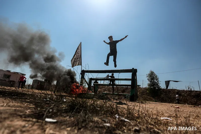 Young Palestinians attend a military summer camp organised by the Islamic Jihad Movement, in Gaza City, June 29, 2021. Photo by Mohammed Dahman Young Palestinians attend a military summer camp organised by the Islamic Ji...