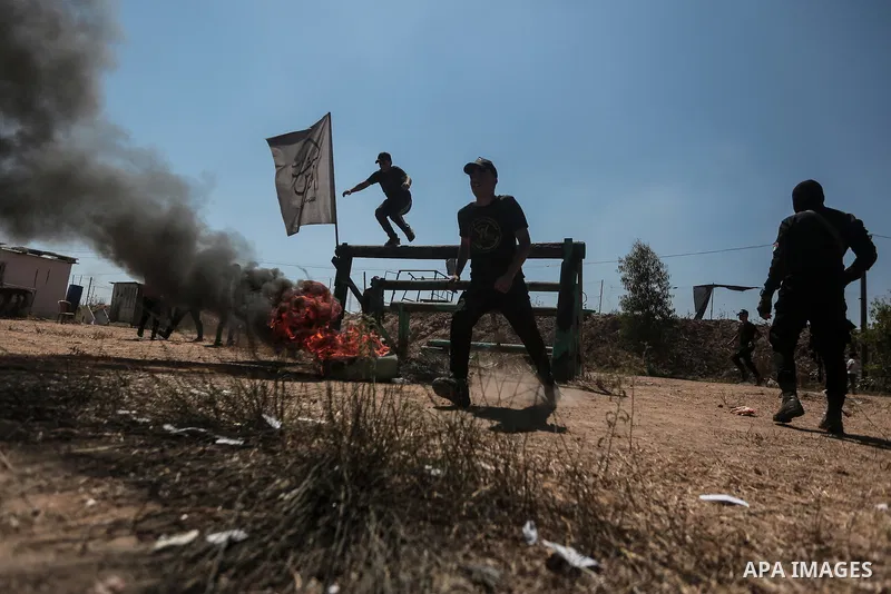 Young Palestinians attend a military summer camp organised by the Islamic Jihad Movement, in Gaza City, June 29, 2021. Photo by Mohammed Dahman Young Palestinians attend a military summer camp organised by the Islamic Ji...