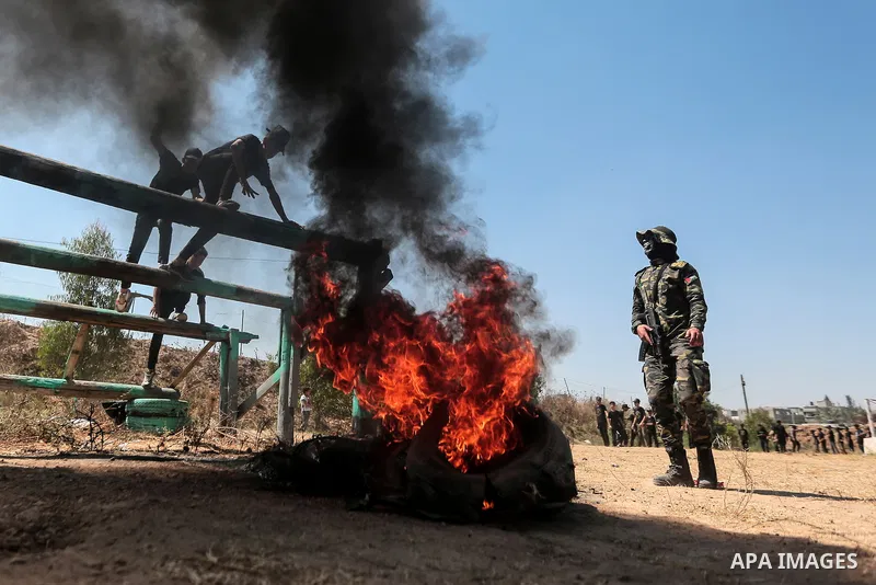 Young Palestinians attend a military summer camp organised by the Islamic Jihad Movement, in Gaza City, June 29, 2021. Photo by Mohammed Dahman Young Palestinians attend a military summer camp organised by the Islamic Ji...