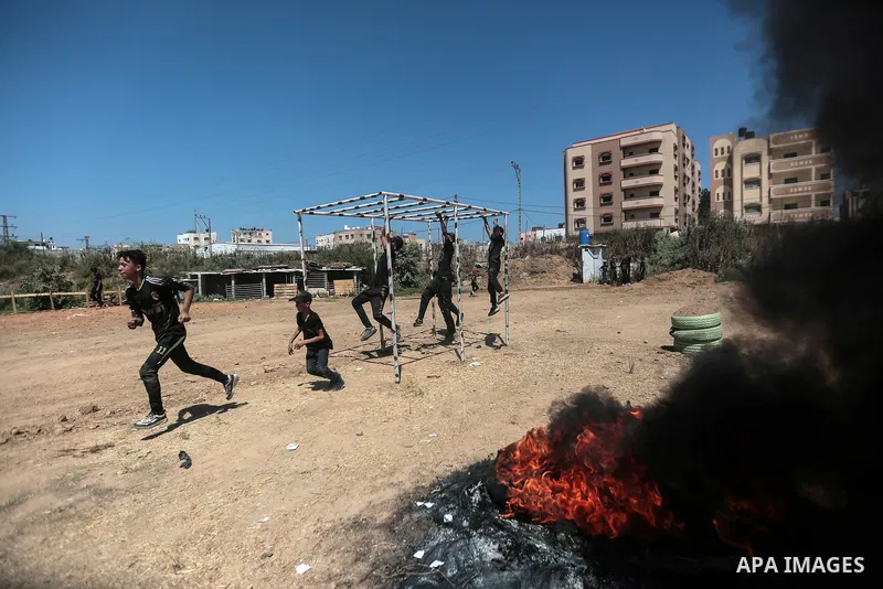 Young Palestinians attend a military summer camp organised by the Islamic Jihad Movement, in Gaza City, June 29, 2021. Photo by Mohammed Dahman Young Palestinians attend a military summer camp organised by the Islamic Ji...