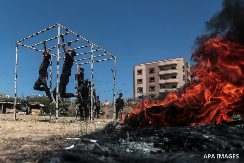 Young Palestinians attend a military summer camp organised by the Islamic Jihad Movement, in Gaza City, June 29, 2021. Photo by Mohammed Dahman Young Palestinians attend a military summer camp organised by the Islamic Ji...