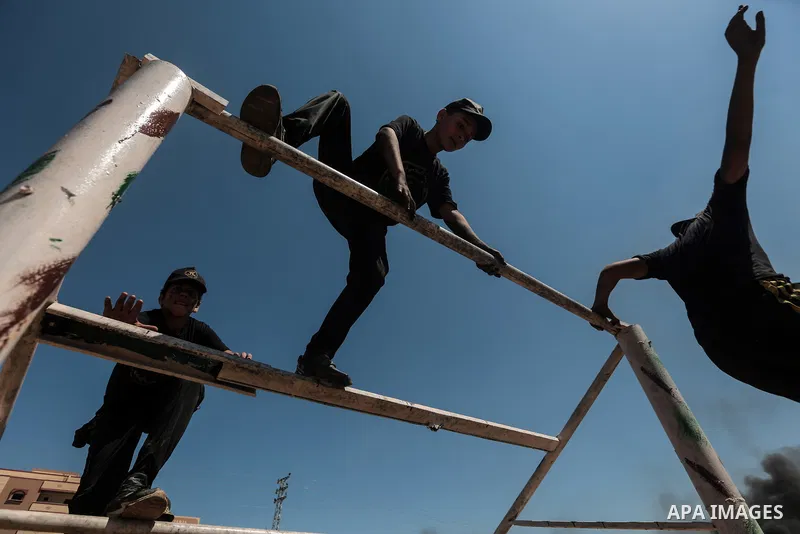Young Palestinians attend a military summer camp organised by the Islamic Jihad Movement, in Gaza City, June 29, 2021. Photo by Mohammed Dahman Young Palestinians attend a military summer camp organised by the Islamic Ji...