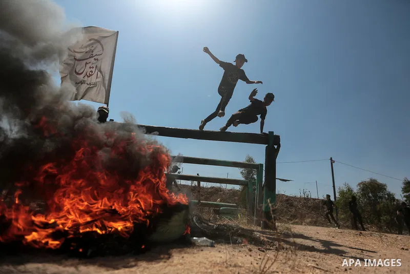 Young Palestinians attend a military summer camp organised by the Islamic Jihad Movement, in Gaza City, June 29, 2021. Photo by Mohammed Dahman Young Palestinians attend a military summer camp organised by the Islamic Ji...