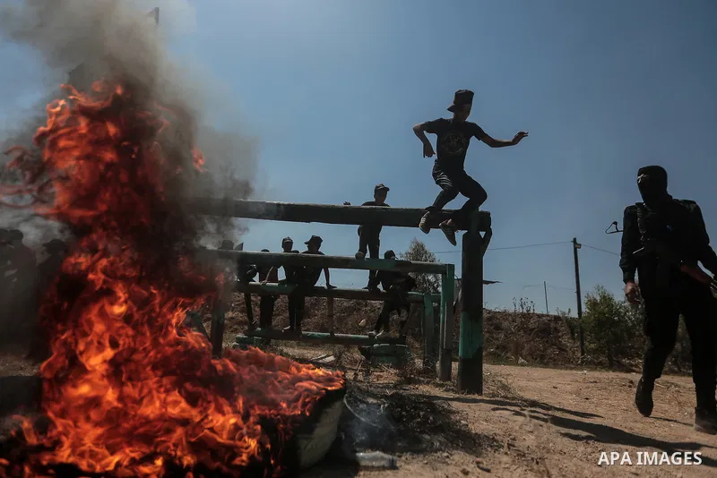 Young Palestinians attend a military summer camp organised by the Islamic Jihad Movement, in Gaza City, June 29, 2021. Photo by Mohammed Dahman Young Palestinians attend a military summer camp organised by the Islamic Ji...
