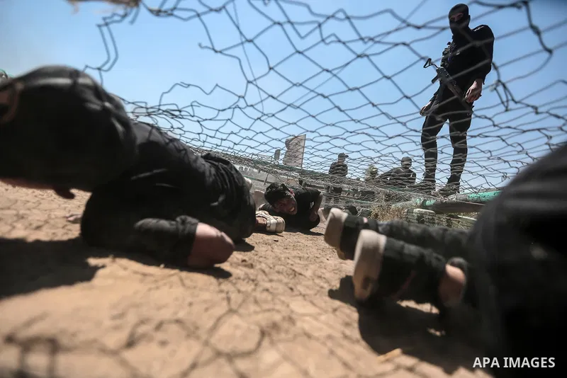 Young Palestinians attend a military summer camp organised by the Islamic Jihad Movement, in Gaza City, June 29, 2021. Photo by Mohammed Dahman Young Palestinians attend a military summer camp organised by the Islamic Ji...