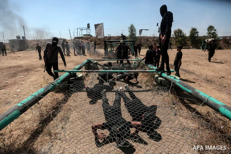 Young Palestinians attend a military summer camp organised by the Islamic Jihad Movement, in Gaza City, June 29, 2021. Photo by Mohammed Dahman Young Palestinians attend a military summer camp organised by the Islamic Ji...