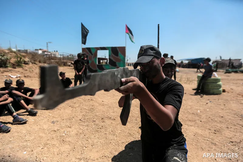 Young Palestinians attend a military summer camp organised by the Islamic Jihad Movement, in Gaza City, June 29, 2021. Photo by Mohammed Dahman Young Palestinians attend a military summer camp organised by the Islamic Ji...