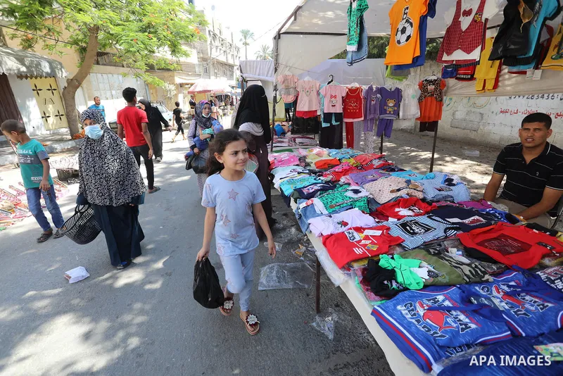 . Photo by Ashraf Amra Palestinians shop at a weekly market in Deir al-Balah in the center of Gaza Strip on June 29, 2021. The authorities in Gaza Strip decided to reopen the popular markets, after its closure, due to th...