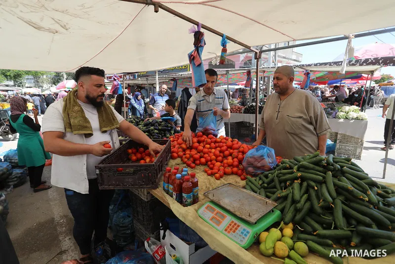 . Photo by Ashraf Amra Palestinians shop at a weekly market in Deir al-Balah in the center of Gaza Strip on June 29, 2021. The authorities in Gaza Strip decided to reopen the popular markets, after its closure, due to th...