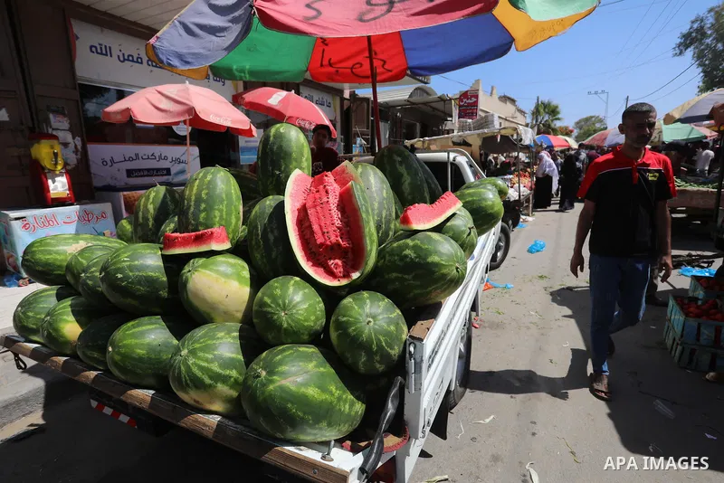 . Photo by Ashraf Amra Palestinians shop at a weekly market in Deir al-Balah in the center of Gaza Strip on June 29, 2021. The authorities in Gaza Strip decided to reopen the popular markets, after its closure, due to th...