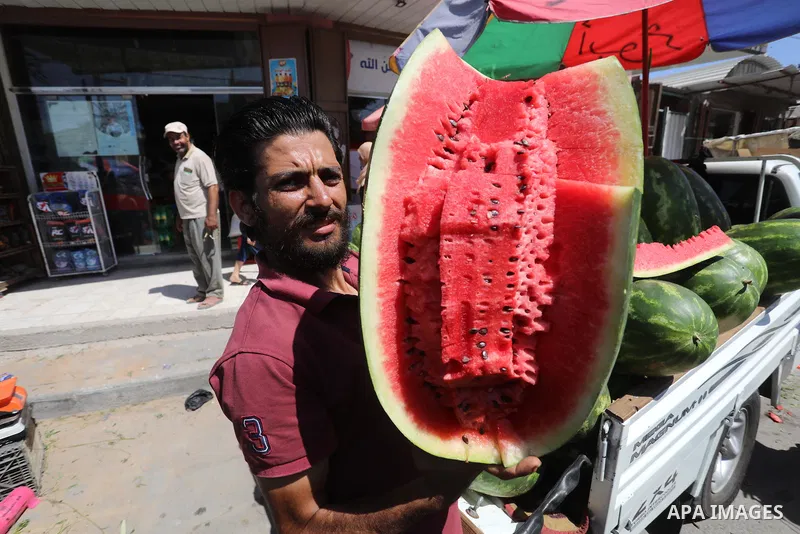 . Photo by Ashraf Amra Palestinians shop at a weekly market in Deir al-Balah in the center of Gaza Strip on June 29, 2021. The authorities in Gaza Strip decided to reopen the popular markets, after its closure, due to th...