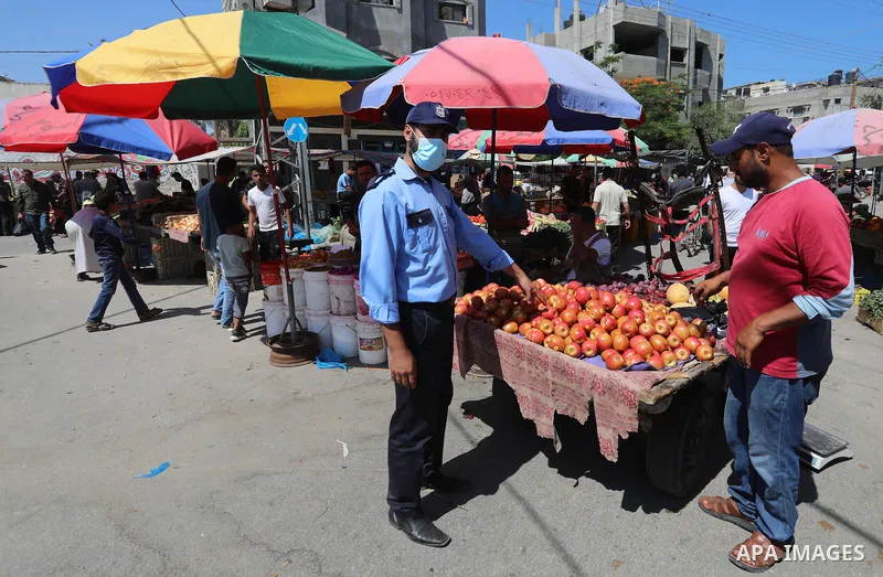 . Photo by Ashraf Amra Palestinians shop at a weekly market in Deir al-Balah in the center of Gaza Strip on June 29, 2021. The authorities in Gaza Strip decided to reopen the popular markets, after its closure, due to th...