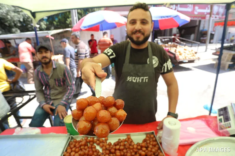 . Photo by Ashraf Amra Palestinians shop at a weekly market in Deir al-Balah in the center of Gaza Strip on June 29, 2021. The authorities in Gaza Strip decided to reopen the popular markets, after its closure, due to th...