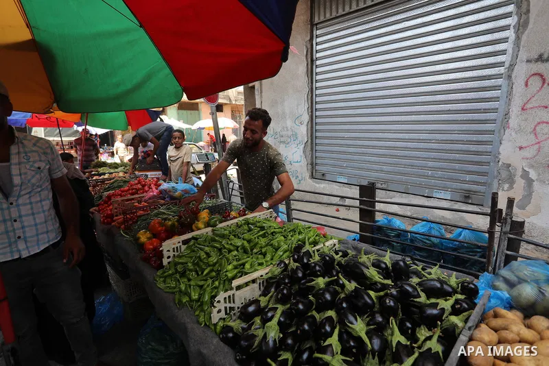 . Photo by Ashraf Amra Palestinians shop at a weekly market in Deir al-Balah in the center of Gaza Strip on June 29, 2021. The authorities in Gaza Strip decided to reopen the popular markets, after its closure, due to th...