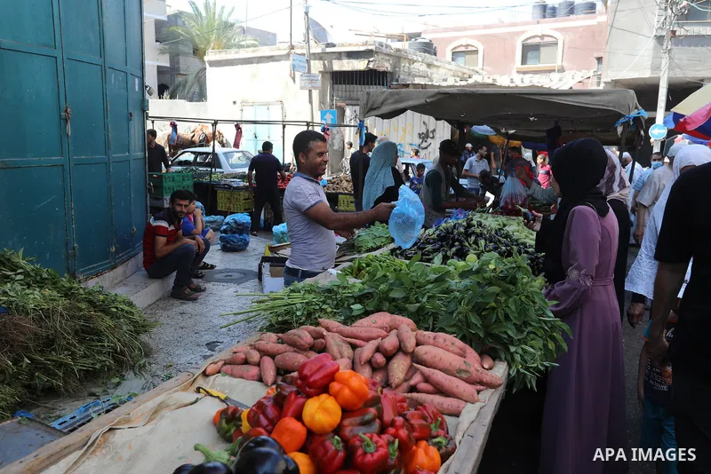 . Photo by Ashraf Amra Palestinians shop at a weekly market in Deir al-Balah in the center of Gaza Strip on June 29, 2021. The authorities in Gaza Strip decided to reopen the popular markets, after its closure, due to th...