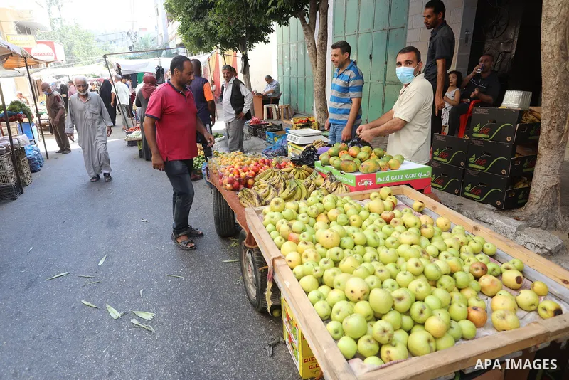 . Photo by Ashraf Amra Palestinians shop at a weekly market in Deir al-Balah in the center of Gaza Strip on June 29, 2021. The authorities in Gaza Strip decided to reopen the popular markets, after its closure, due to th...