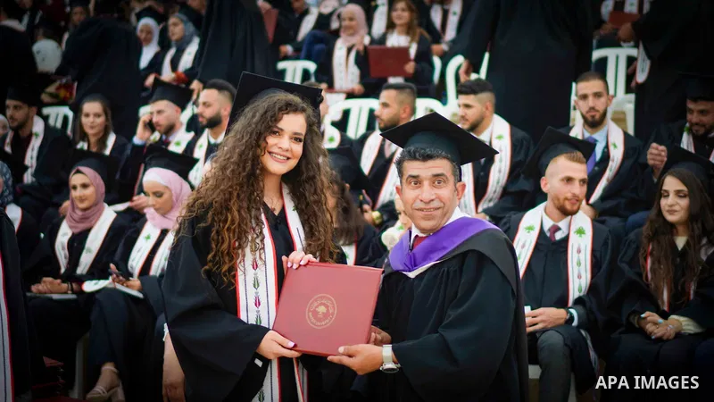 Palestinian students attend their graduation ceremony at Birzeit University in the West Bank city of Ramallah, on June 29, 2021. Photo by Eyad Jadallah