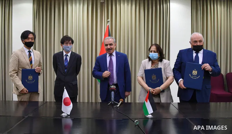 Palestinian Prime Minister Mohammed Ishtayeh attend the ceremony of signing a grant agreement from Japan worth 8 million dollars to confront Coronavirus, in the West Bank city of Ramallah on June 30, 2021. Photo by Prime...