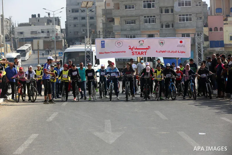 Palestinians take part in a bike race championship including disabled people, in Gaza city, on June 30, 2021. Photo by Ashraf Amra