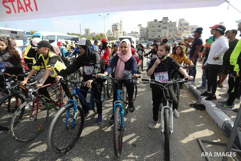 Palestinians take part in a bike race championship including disabled people, in Gaza city, on June 30, 2021. Photo by Ashraf Amra