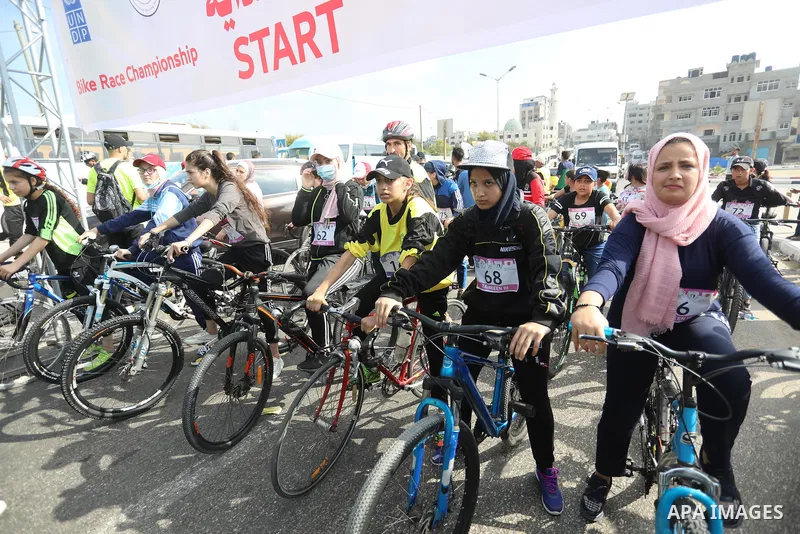 Palestinians take part in a bike race championship including disabled people, in Gaza city, on June 30, 2021. Photo by Ashraf Amra