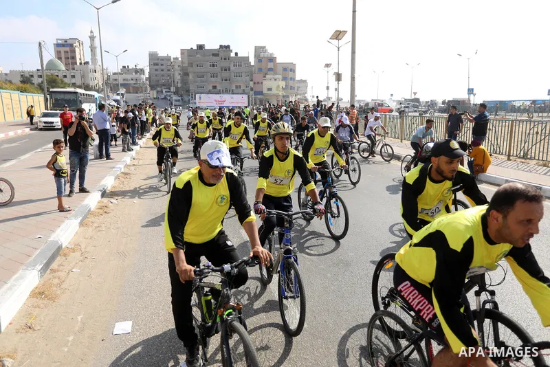 Palestinians take part in a bike race championship including disabled people, in Gaza city, on June 30, 2021. Photo by Ashraf Amra