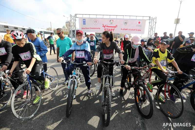 Palestinians take part in a bike race championship including disabled people, in Gaza city, on June 30, 2021. Photo by Ashraf Amra