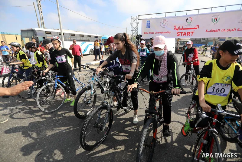 Palestinians take part in a bike race championship including disabled people, in Gaza city, on June 30, 2021. Photo by Ashraf Amra