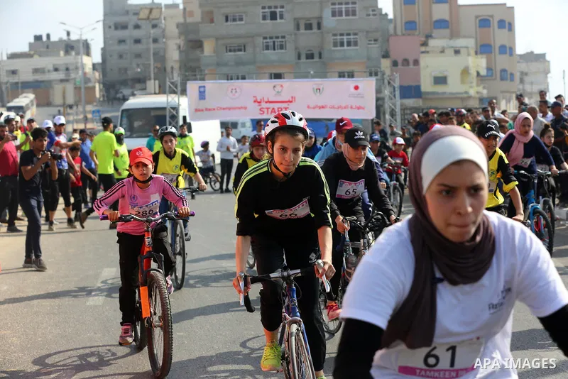 Palestinians take part in a bike race championship including disabled people, in Gaza city, on June 30, 2021. Photo by Ashraf Amra