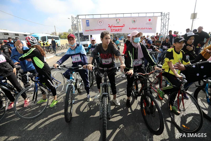 Palestinians take part in a bike race championship including disabled people, in Gaza city, on June 30, 2021. Photo by Ashraf Amra