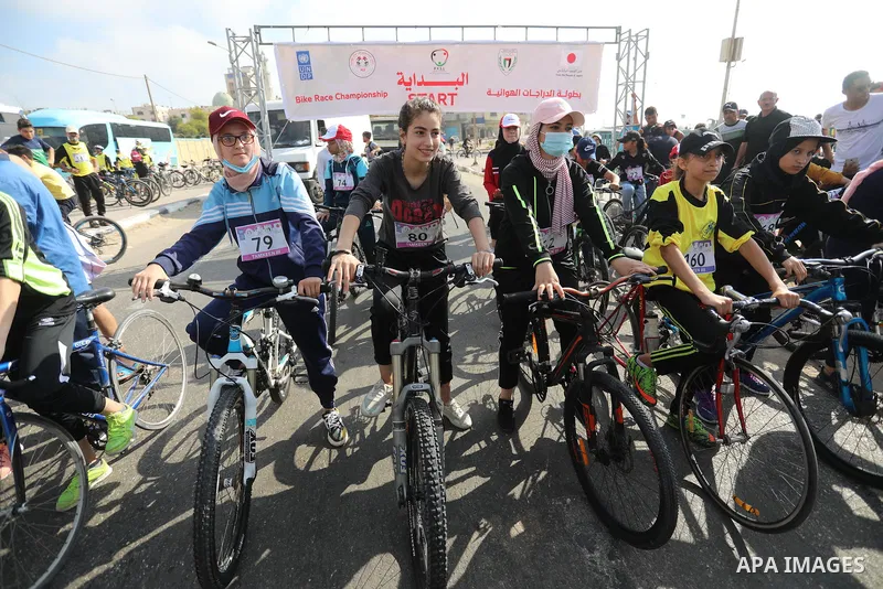 Palestinians take part in a bike race championship including disabled people, in Gaza city, on June 30, 2021. Photo by Ashraf Amra