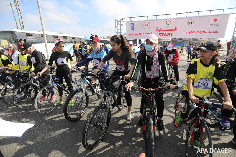 Palestinians take part in a bike race championship including disabled people, in Gaza city, on June 30, 2021. Photo by Ashraf Amra