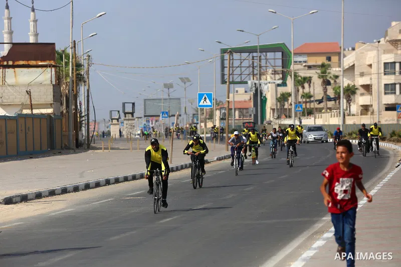 Palestinians take part in a bike race championship including disabled people, in Gaza city, on June 30, 2021. Photo by Ashraf Amra