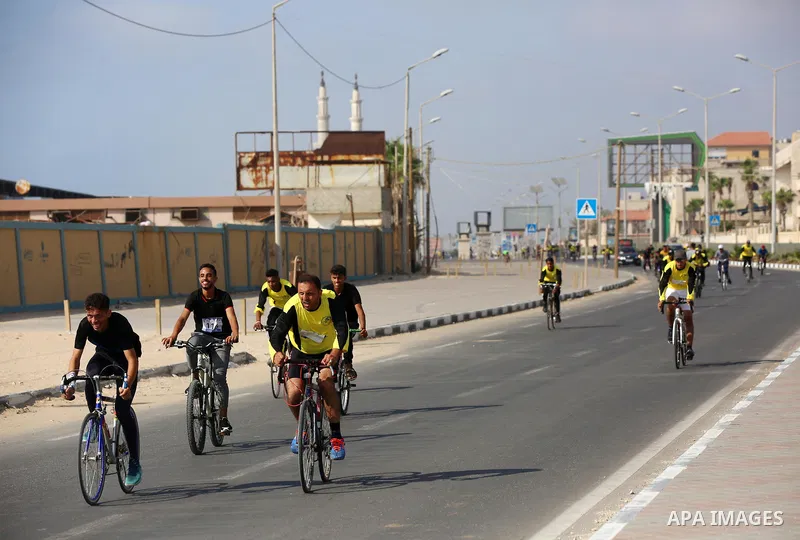 Palestinians take part in a bike race championship including disabled people, in Gaza city, on June 30, 2021. Photo by Ashraf Amra