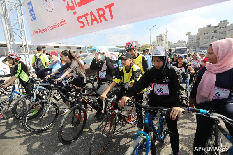 Palestinians take part in a bike race championship including disabled people, in Gaza city, on June 30, 2021. Photo by Ashraf Amra