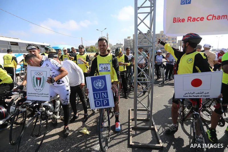 Palestinians take part in a bike race championship including disabled people, in Gaza city, on June 30, 2021. Photo by Ashraf Amra