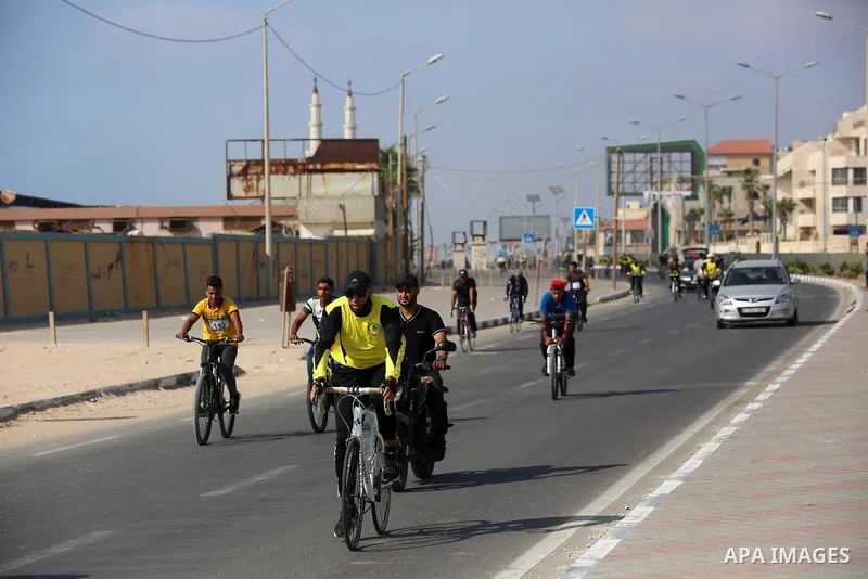 Palestinians take part in a bike race championship including disabled people, in Gaza city, on June 30, 2021. Photo by Ashraf Amra