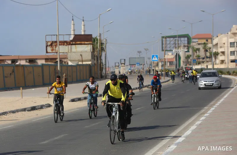 Palestinians take part in a bike race championship including disabled people, in Gaza city, on June 30, 2021. Photo by Ashraf Amra