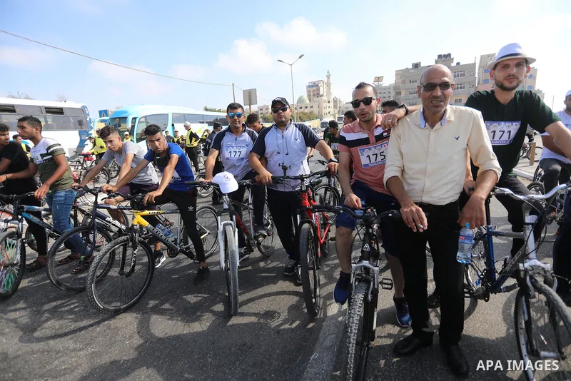 Palestinians take part in a bike race championship including disabled people, in Gaza city, on June 30, 2021. Photo by Ashraf Amra