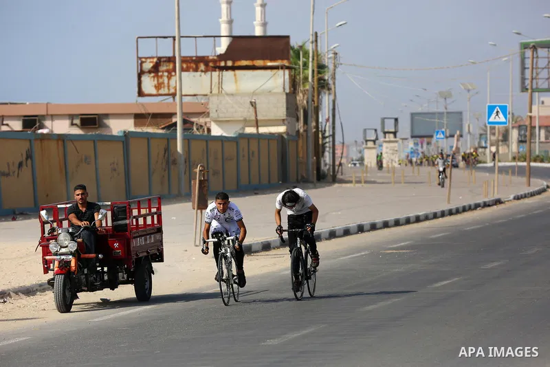 Palestinians take part in a bike race championship including disabled people, in Gaza city, on June 30, 2021. Photo by Ashraf Amra