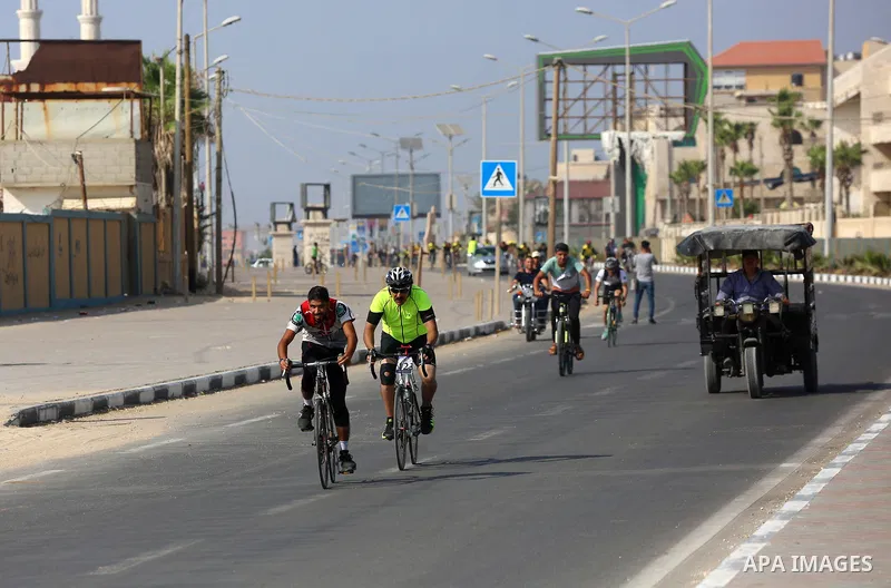 Palestinians take part in a bike race championship including disabled people, in Gaza city, on June 30, 2021. Photo by Ashraf Amra