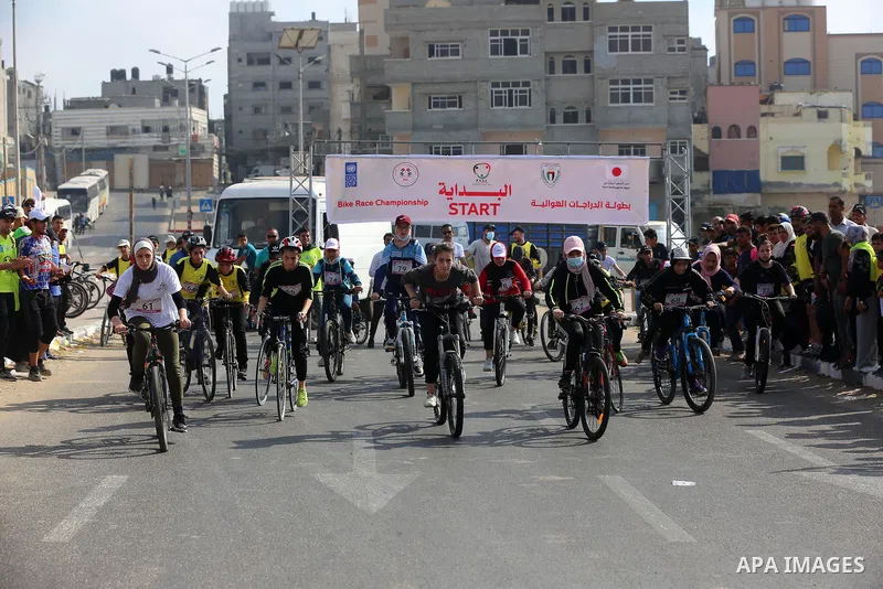 Palestinians take part in a bike race championship including disabled people, in Gaza city, on June 30, 2021. Photo by Ashraf Amra