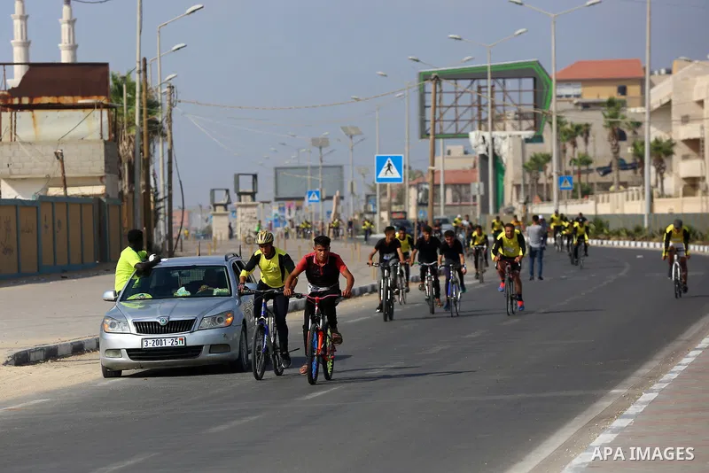 Palestinians take part in a bike race championship including disabled people, in Gaza city, on June 30, 2021. Photo by Ashraf Amra