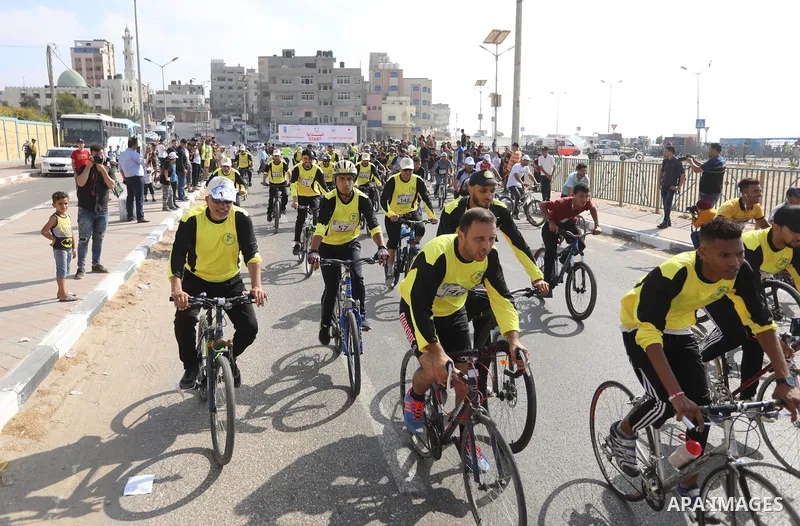 Palestinians take part in a bike race championship including disabled people, in Gaza city, on June 30, 2021. Photo by Ashraf Amra