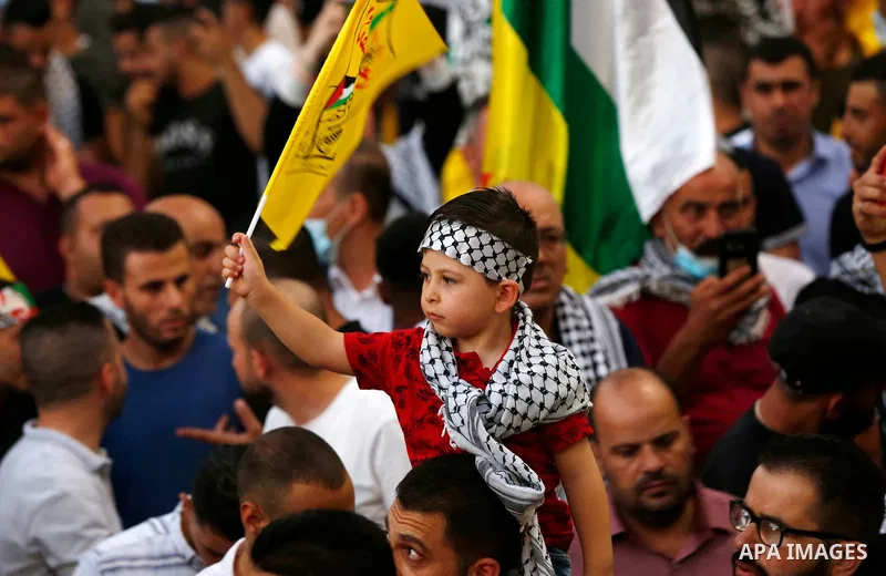 Palestinian supporters Fatah movement take part in a rally in support of Palestinian president Mahmud Abbas in the West Bank city of Nablus on June 30, 2021. Photo by Stringer